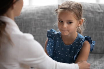 Close up of supportive young Caucasian mother touch caress unhappy sad little teen daughter feeling...