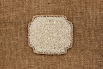 Frame made of rope with a whole, ripe rice grain. With space for design, text place.