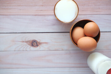 top view of glass of milk and egg on table with copy space 