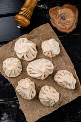 Georgian homemade food called khinkali. Georgian cuisine. On wooden background