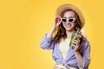 Summer refreshment. Cold beverage. Happy woman in sunglasses holding plastic glass of mojito. Non-alcoholic drink. Detox lemonade.