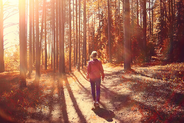 female sports style autumn forest, fitness tourism in a yellow park leaf fall sun