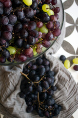 Grapes in a vase. Close up photo of fresh seasonal fruits. Eating fresh concept. Beautiful grapes on a table. Summer berries texture. 