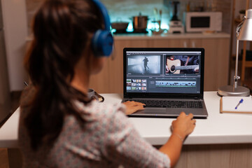 Movie maker editing a film using modern software for post production. Content creator in home working on montage of film using modern software for editing late at night.