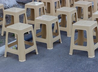 Lightweight plastic chairs are arranged for a small event. Lockdown period - no viewers