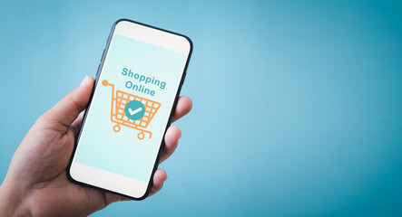 close up hands using touch screen smartphone for online shopping. Mobile phone with online shopping application on screen, payment concept with blue background.