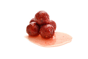 Close up view of red boilies in dip, fishing baits for carp isolated on white background