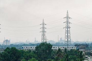 A wide shot of kochi metro moving through the track on a foggy morning pic was taken on 11 April 2021 at kochi India