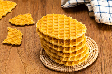 High angle view stack of homemade crispy waffles on bamboo mat.