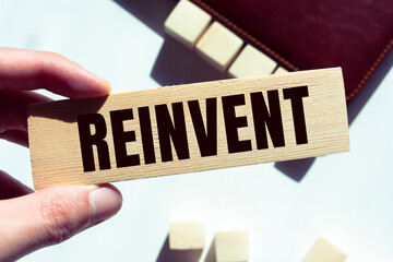 Wooden Blocks with the text: Reinvent