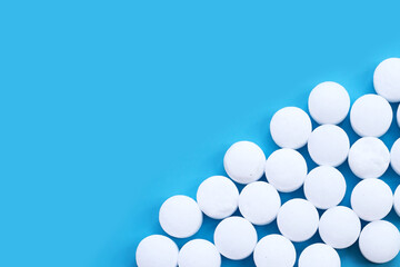 Naphthalene mothballs on blue backgrond.