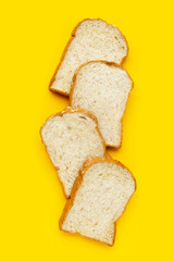 Fototapeta na wymiar Sliced wholegrain bread on yellow background.