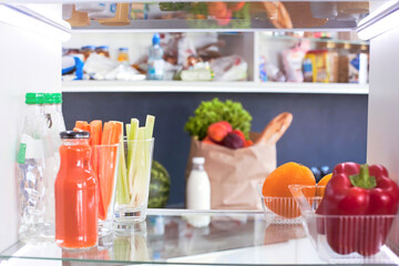 Open refrigerator with fresh fruits and vegetable
