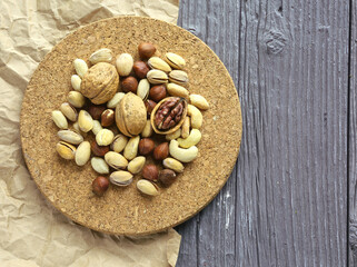 Nuts decorated in a plate on a wooden desk