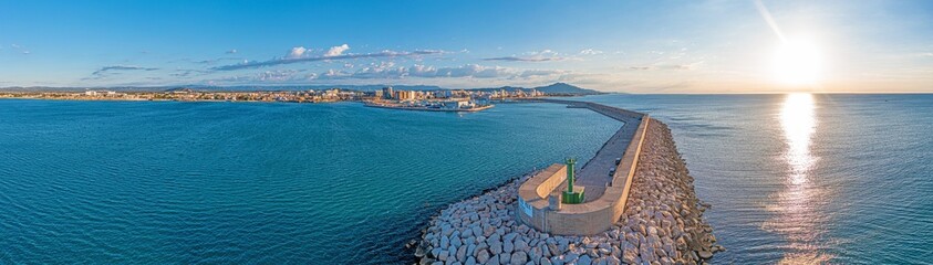Drone panorama of the Spanish town of Vinaros with the large breakwater at the entrance to the port...