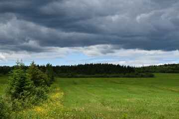 A cultivated field under a stormy sky, Québec, Canada
