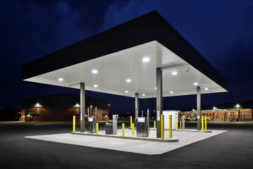 View of well-lit gas station at night