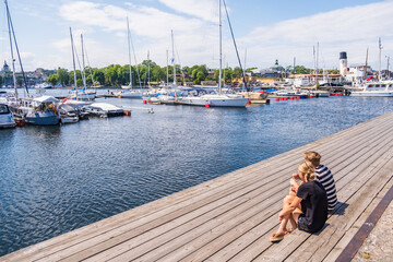 Stockholm Sweden - July 4 2021: Relaxing atmosphere in the port of Djurgarden. Sunny weather and peaceful atmosphere. Popular tourist destination in Scandinavia.