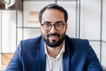 Online zoom video call with Arabian successful businessman boss CEO colleague. Front view online remote distant conversation on laptop. E-learning, tutoring