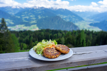 traditional local kaspressknodel cheese dumpling in tirol austria with mountain view landscape - obrazy, fototapety, plakaty