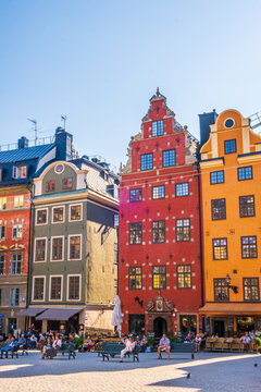 Stockholm Sweden - July 1 2021: Colourful historic buildings and houses in Gamla Stan, Main S. Romantic medieval city centre alleys. Popular tourist destination in Scandinavia on a sunny day.