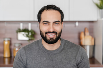 Close up portrait of mature young Middle Eastern Arabian muslim islamic handsome man showing toothy smile looking in camera. Husband, trustful father, colleague, tutor, tenant, freelancer, student. - obrazy, fototapety, plakaty