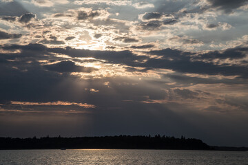 Naklejka na ściany i meble Sunset on the lake during a cloudy sky