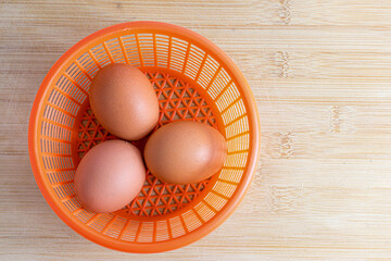 eggs in a basket  on wooden  table