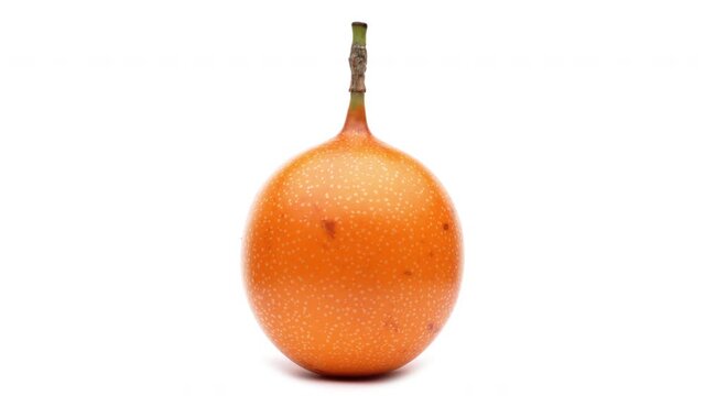 Closeup of one sweet granadilla rotating on the turntable. Isolated on white background.
