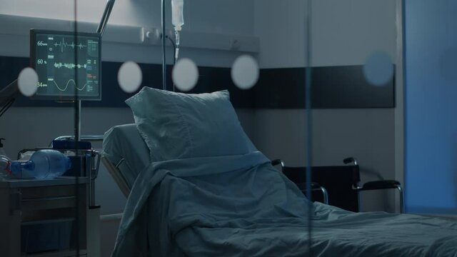 Hospital ward with empty bed at clinical facility for health problems treatment, surgery recovery and intensive care. Nobody in emergency room designed with equipment for healing