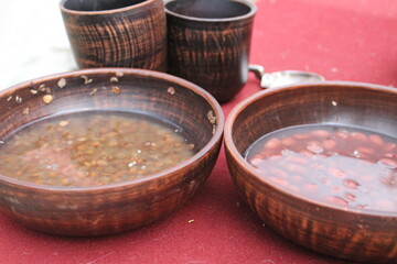 lentils and beans soaked in water in a wooden dish for cooking