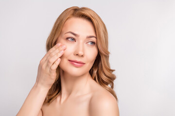 Photo portrait woman after shower naked shoulders applying anti age face cream looking empty space...
