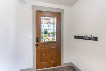 Interior of a front door with wall rail-mounted hanging hooks