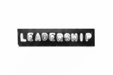 Embossed letter with word leadership in black banner on white paper background