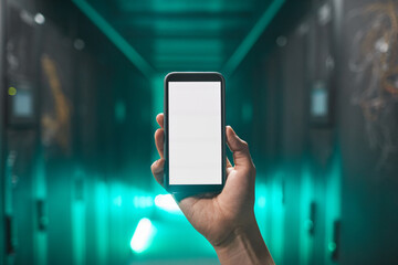 Close up of male hand holding smartphone with blank white screen in futuristic server room, copy...