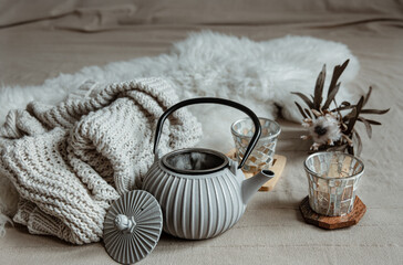 Cozy home composition with teapot and home decor details.