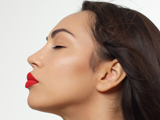 Closeup portrait of a woman with developing straight hair. Sweet tender young girl, brunette. Red lipstick on the lips, transparent transparent skin. Beauty, spa, injections, cosmetology, beautiful