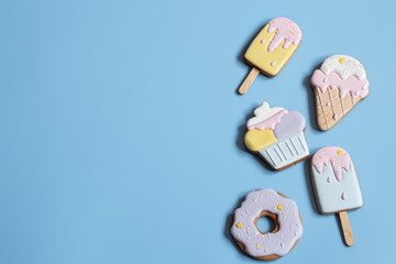 Flat lay bright glazed cookies of different shapes.