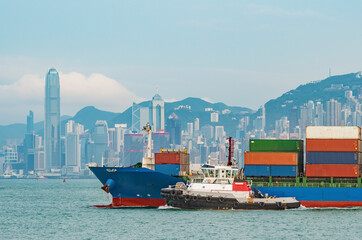 Cargo ship in Victoria Harbor of Hong Kong city - 444758323