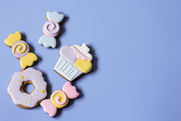 Colorful festive gingerbread cookies of different shapes covered with glaze.