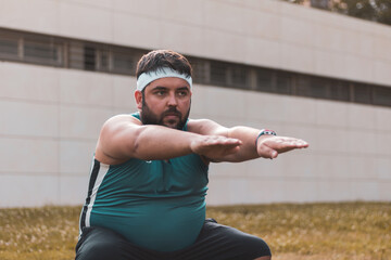a fat man doing a squat outdoors.