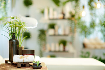 towel, hot stone massage and cosmetics in modern beauty studio