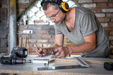 A carpenter works with professional woodworking tools.