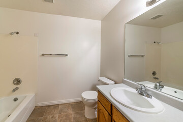 Inside a tile flooring bathroom with vanity sink and shower tub combo