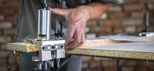 Professional carpenter working with wood and building tools.
