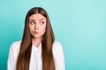 Photo of young unhappy doubtful teenager look empty space bad mood isolated on pastel teal color...