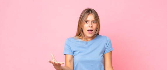 blonde pretty woman looking angry, annoyed and frustrated screaming wtf or what’s wrong with you