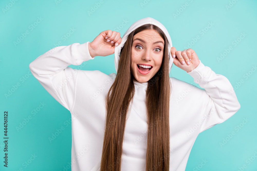 Poster Photo of young amazed happy positive woman wear head hood astonished face isolated on teal color background