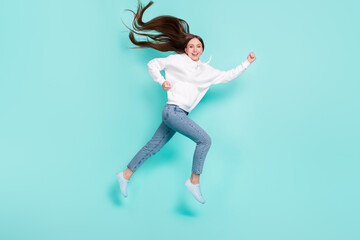 Fototapeta na wymiar Full length body size view of pretty cheerful motivated girl jumping running isolated over bright teal turquoise color background