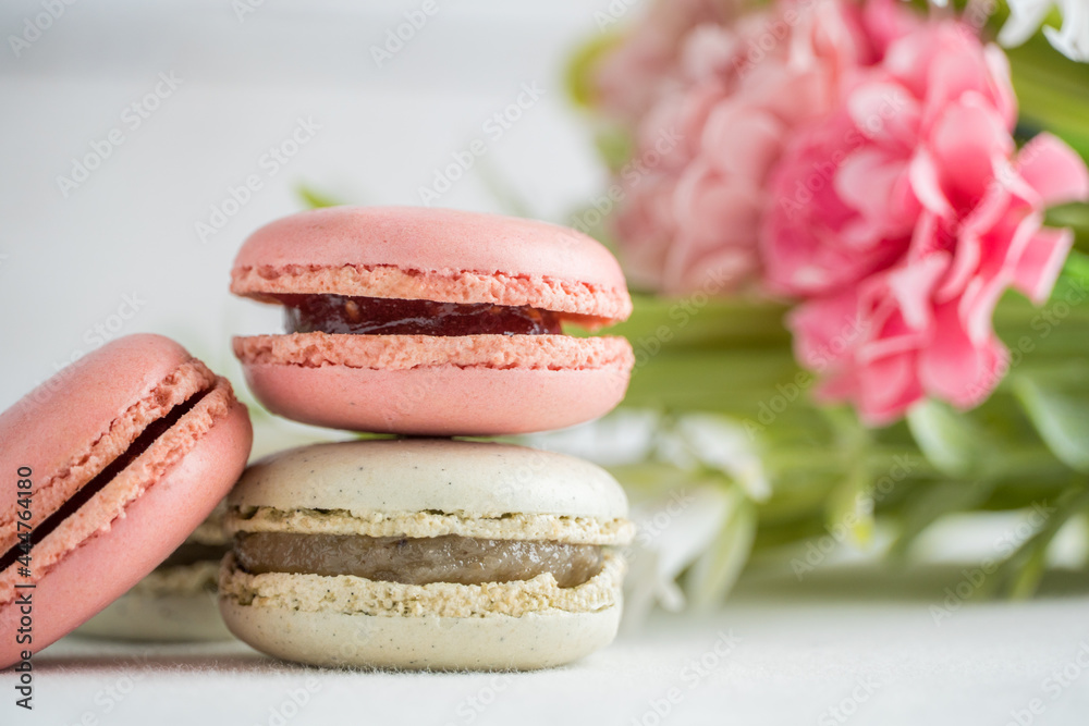 Wall mural colorful macarons with flowers and white background